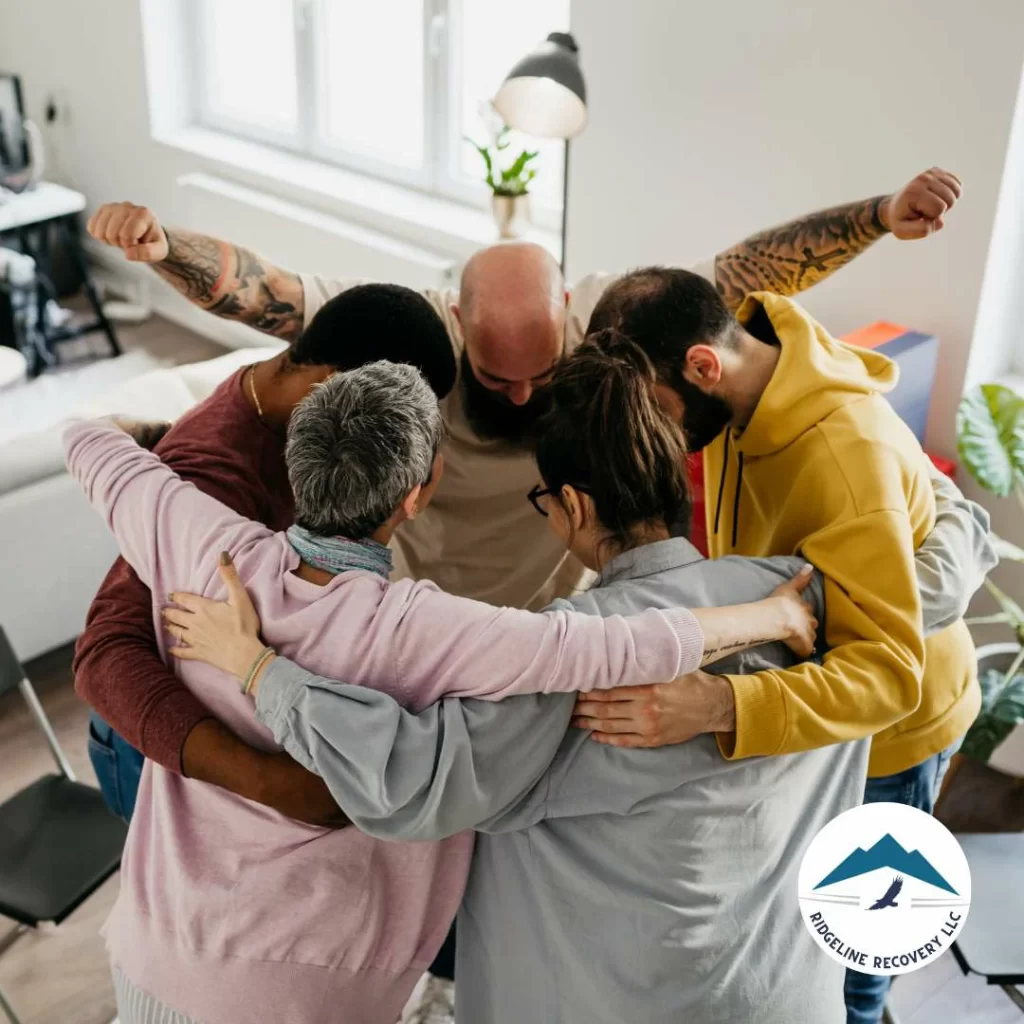 A  group of individual, hugging each other after the addiction therapy services