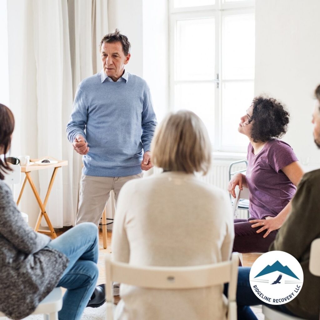 A therapist conducting a group discussion in Addiction Therapy Services, emphasizing the connection between mental health and addiction recovery.