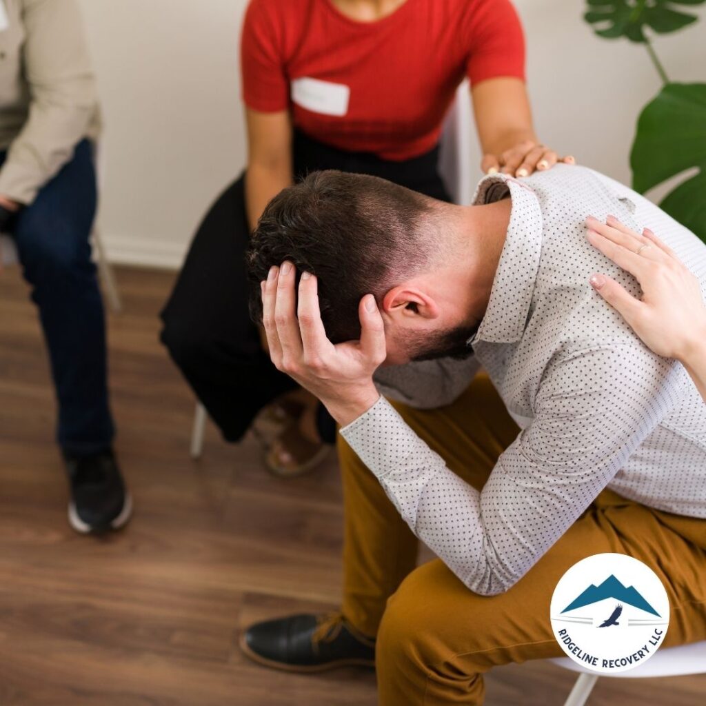 A group of people in a therapy session at Ridgeline Recovery in Columbus, Ohio, discussing their experiences with addiction and recovery. The image conveys a sense of community, support, and hope.