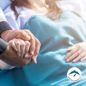 A supportive handhold between a recovering patient and a loved one, symbolizing the healing journey in long-term inpatient rehab near me.