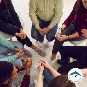 A close-up view of a support group session at a drug rehab in Columbus, Ohio, where individuals hold hands and offer encouragement during addiction recovery.