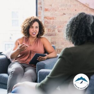 A professional counselor engages in a one-on-one session with a client, discussing the benefits and structure of Court Mandated Substance Abuse Treatment in Ohio within a supportive recovery setting.