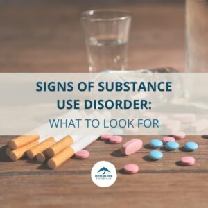 A table with cigarettes, prescription pills, and a glass of alcohol, with a text overlay that reads: "Signs of Substance Use Disorder: What to Look For." The image includes the Ridgeline Recovery logo at the bottom.