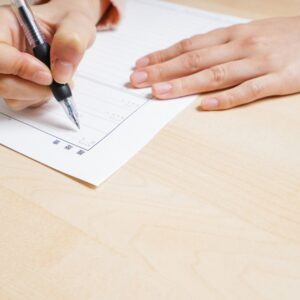 A person filling out Addiction Worksheets, using structured exercises to support self-reflection and recovery.