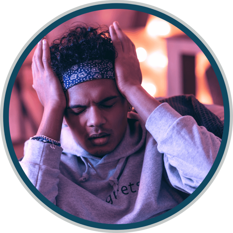 a man holding his head with his hands