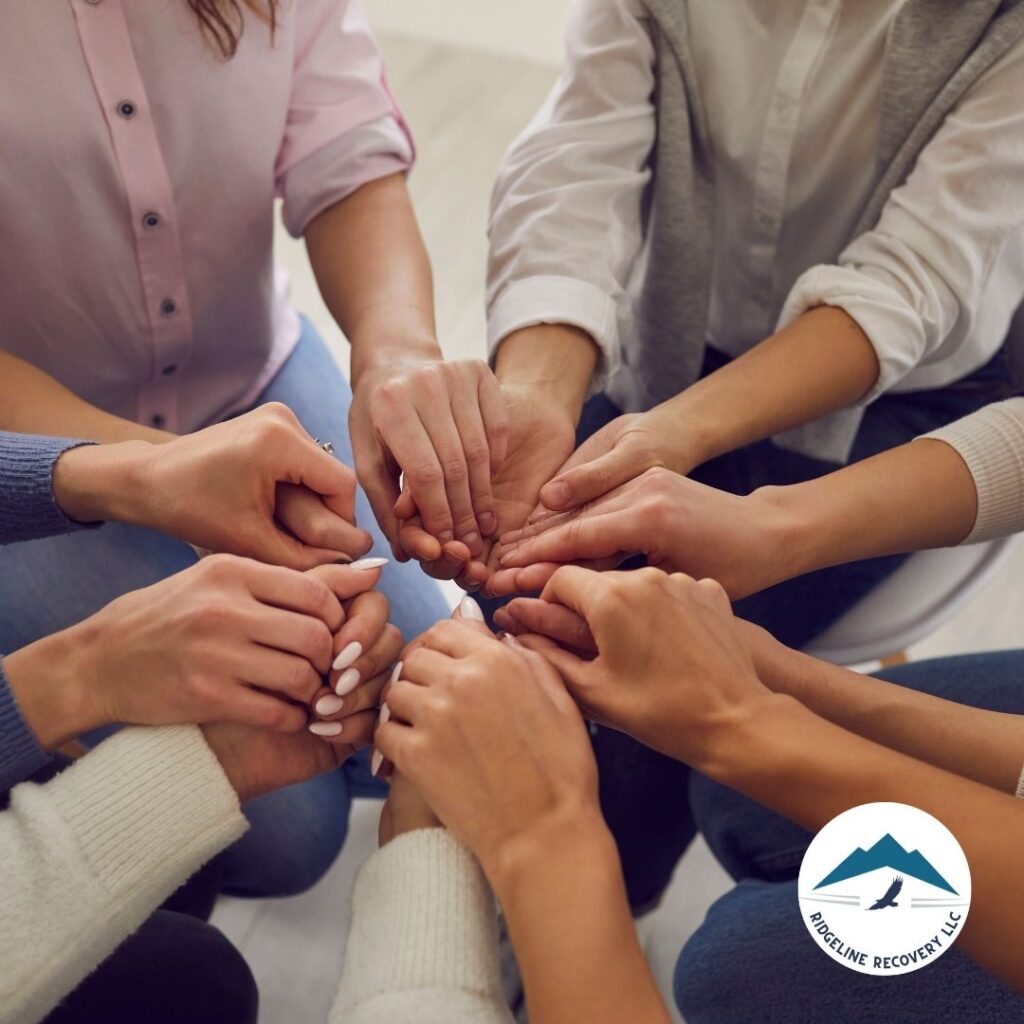 A licensed therapist facilitating a group session focused on addiction therapy services, encouraging participants to share their experiences.