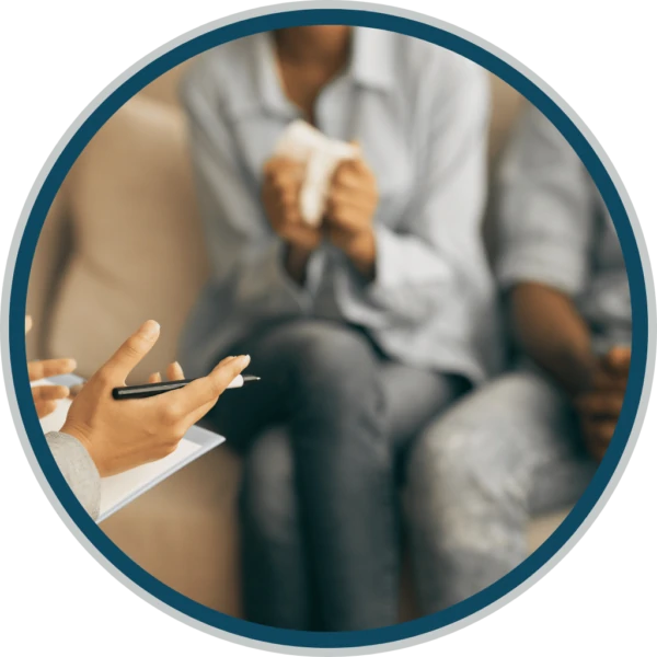 A counselor attentively explaining a treatment plan to a patient in a supportive environment. The counselor is using visual aids, highlighting key points to ensure the patient understands their recovery journey. This interaction emphasizes the importance of clear communication and collaboration in the path to healing at Ridgeline Recovery.