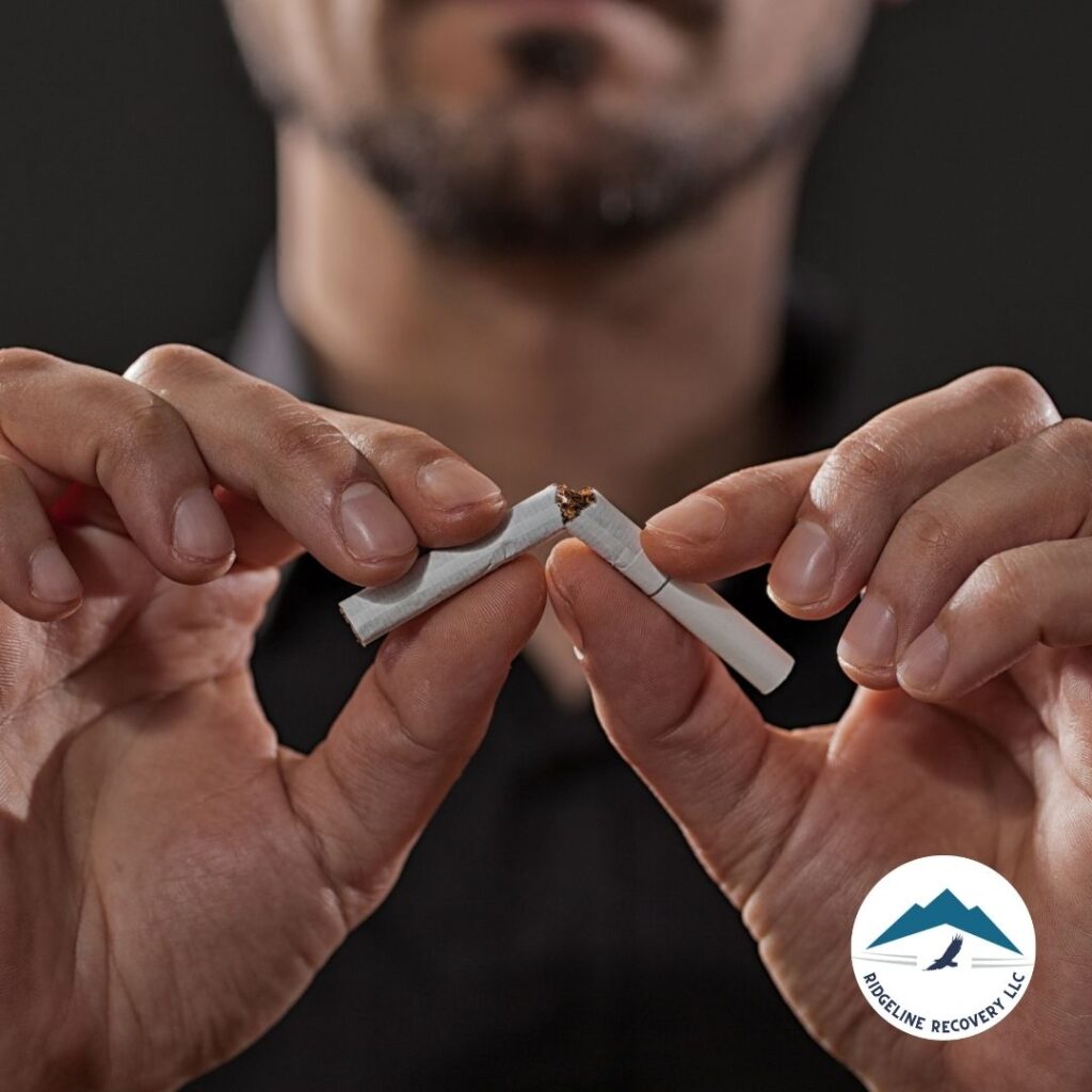 A person breaking a cigarette in half, symbolizing their commitment to quitting smoking and embracing a healthier lifestyle. This image represents the power of addiction treatment in Columbus, Ohio, and the potential for lasting recovery.