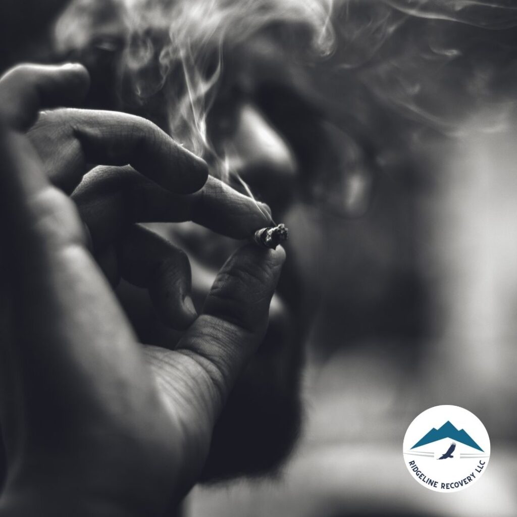 A close-up image of a hand holding a lit cigarette, symbolizing the physical and psychological grip of addiction. This image highlights the destructive nature of addiction and the need for professional help. Addiction treatment programs in Columbus, Ohio, offer comprehensive therapy and support to help individuals break free from addiction and achieve lasting recovery.