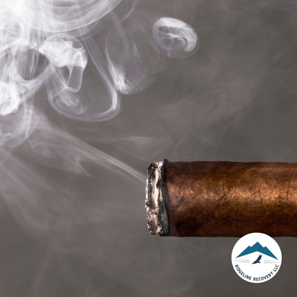 A lit cigar with smoke rising, symbolizing the addictive nature of substances and the need for intensive treatment. Day treatment programs Addiction Recovery Columbus, Ohio, provide structured support and therapy to help individuals overcome addiction and achieve lasting recovery.