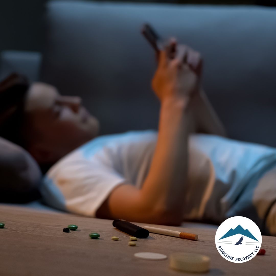 A person lying on a couch with scattered pills and a cigarette nearby, representing the struggle of addiction and the possibility of transformation through a 2 Week Rehab program.