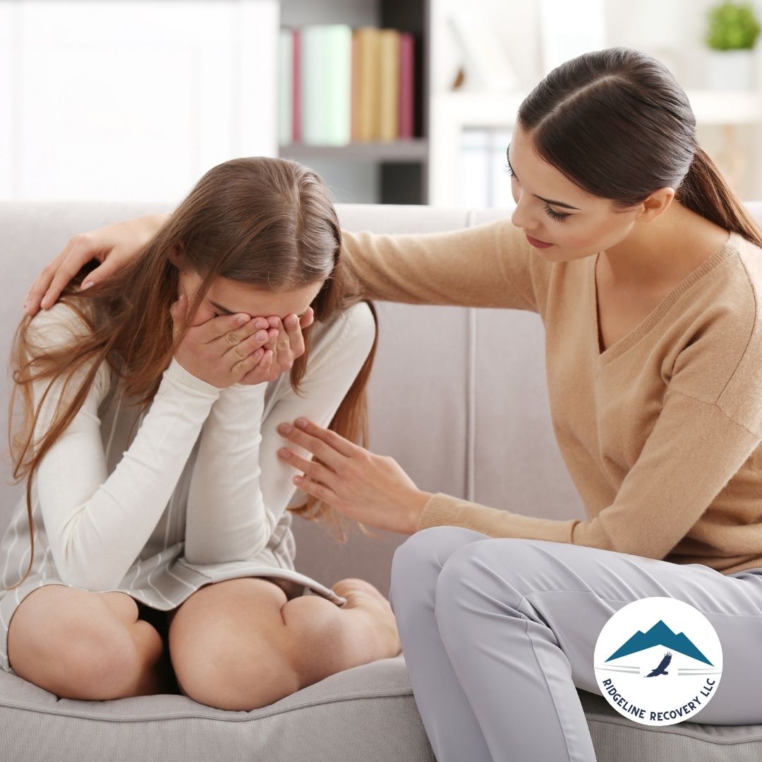 A young woman in distress is comforted by a counselor offering support. Inpatient Programs at Residential Treatment Centers Ohio provide a safe and structured environment for individuals to heal from addiction.