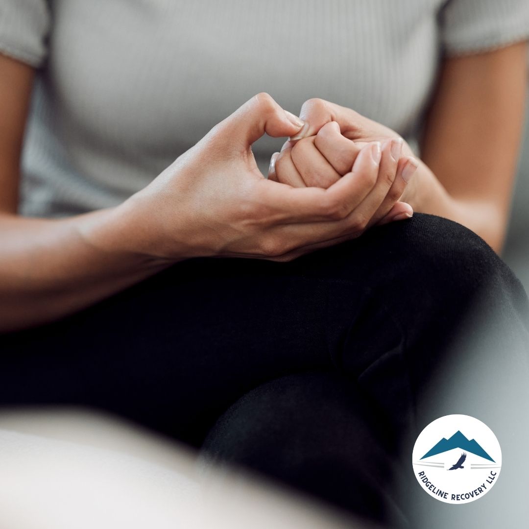 A close-up of a person's hands clasped together in a moment of anxiety or contemplation, representing the difficult but necessary decisions involved in utilizing Casey’s Law in Ohio for addiction recovery.