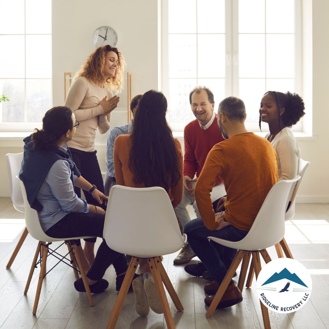 A diverse group of individuals sits in a circle, engaged in a positive and supportive group therapy session. This setting represents the healing environment offered by the Best Inpatient Mental Health Facilities in Ohio, where individuals receive professional care and peer support to aid in their recovery journey.