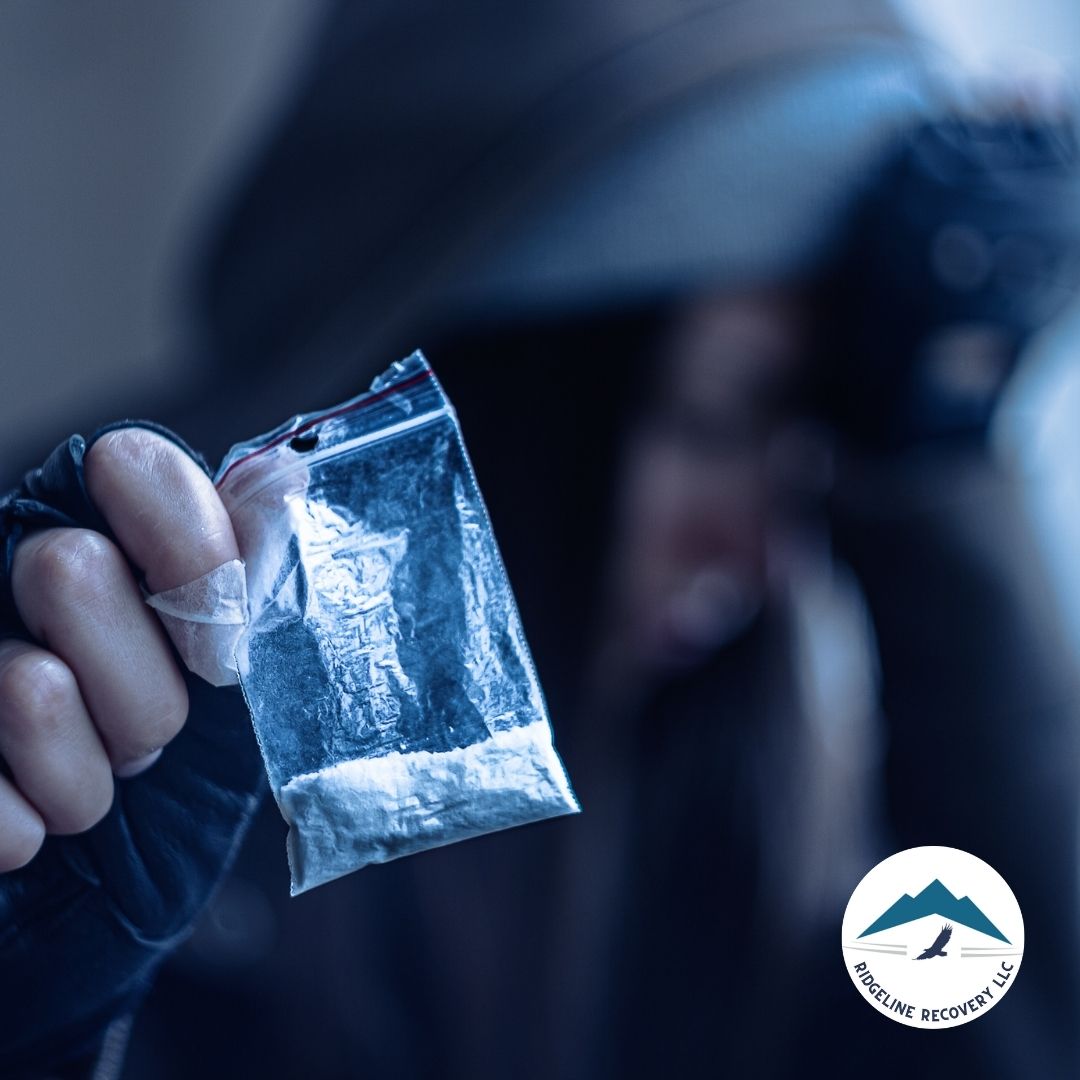 A close-up of a person holding a small bag of white powder, symbolizing drug addiction and the need for intervention through Baker Act Ohio, which provides emergency mental health treatment for those at risk.