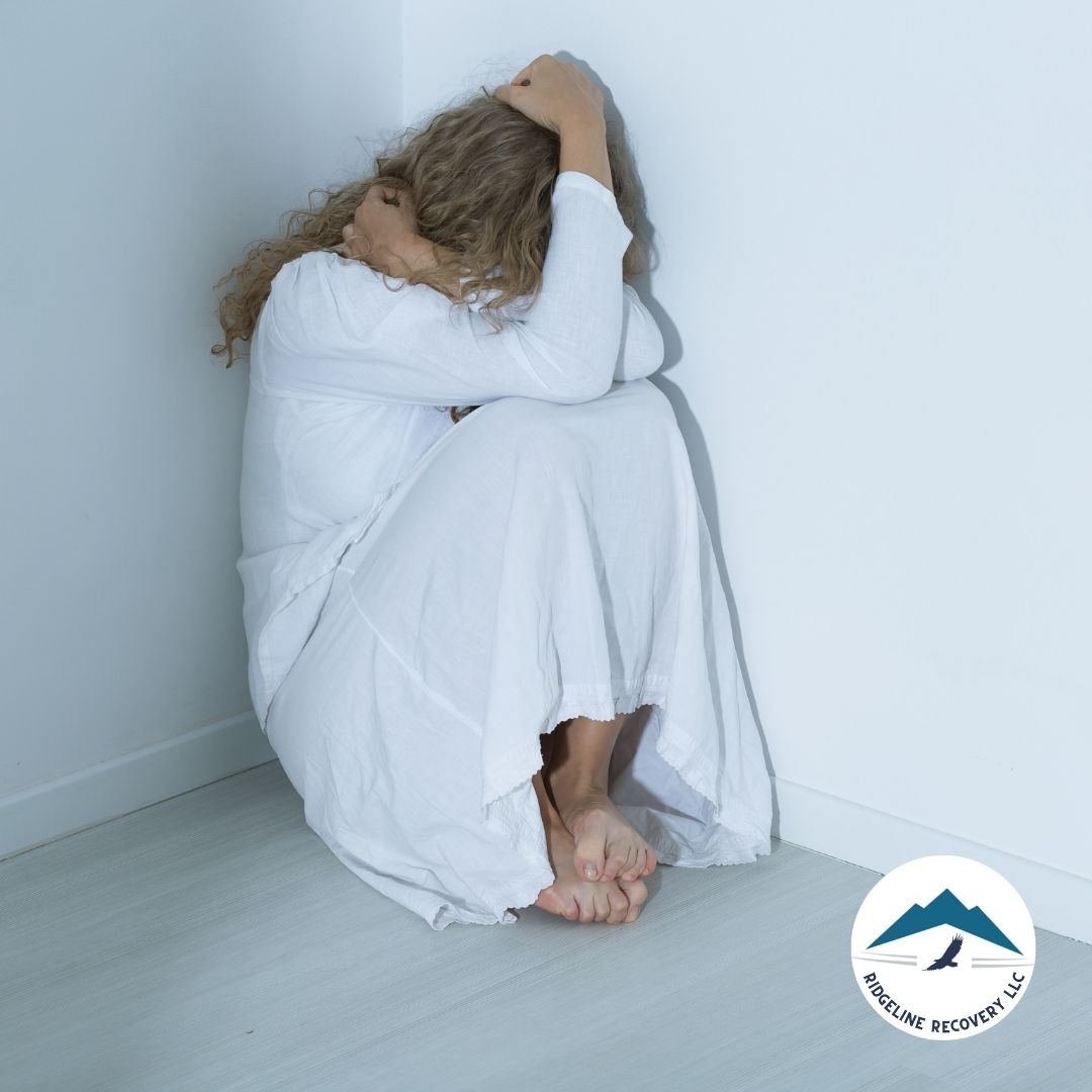 A woman in distress sits curled up in a corner, symbolizing the emotional and physical toll of addiction. Vivitrol Clinic Near Me provides medication-assisted treatment (MAT) to ease withdrawal symptoms and support long-term recovery.