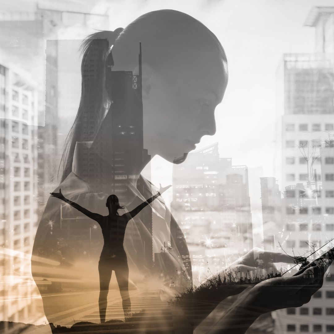 A double-exposure image of a woman deep in thought, overlaid with a cityscape and a silhouette of a person with arms raised, symbolizing the strength of Positive Affirmations for Recovery in achieving mental clarity and sobriety.