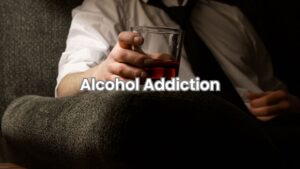 A man drinks alcohol in a dark room, showing signs of stress and alcohol addiction.