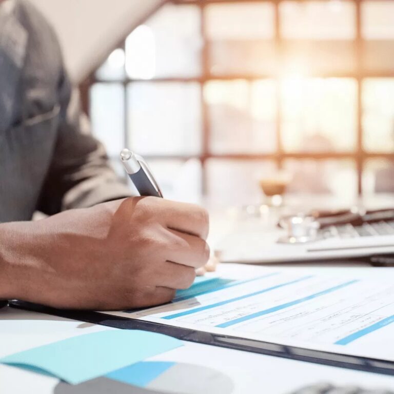 This image shows a professional in formal attire documenting Medicaid program details.