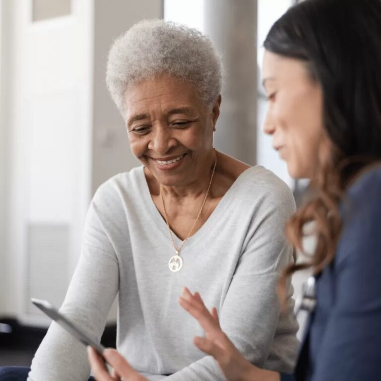 This image features a woman and her therapist in a comfortable setting, representing the safe space created through Medicaid-assisted programs.