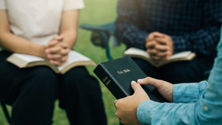 A serene outdoor area at a Christian rehab facility in Columbus promoting peace and healing. Participants are gathered to pray.
