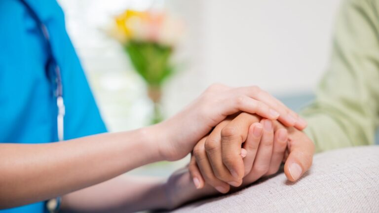 Registered nurse comforting a patient during a recovery health check-in as part of registered nurse services in Columbus.