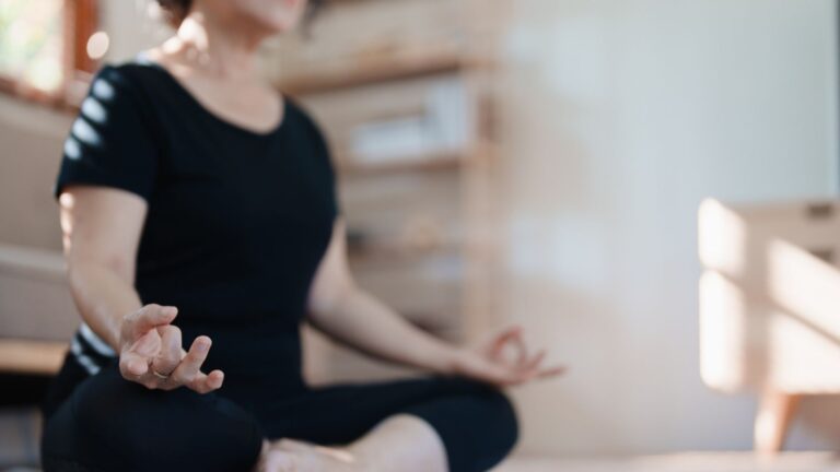 Person meditating at a wellness center in Columbus for stress management.