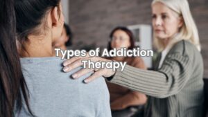 A therapist or counselor leads a group therapy session focused on addiction therapy.