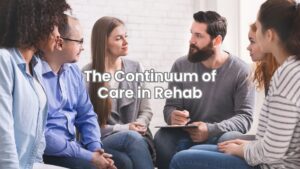 Individuals in a group counseling session sit in a circle offering support during addiction treatment.