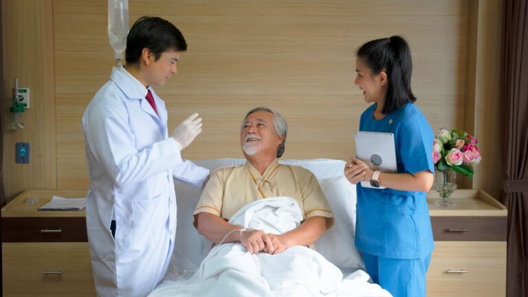A doctor and a nurse working with patients in an inpatient rehab facility.