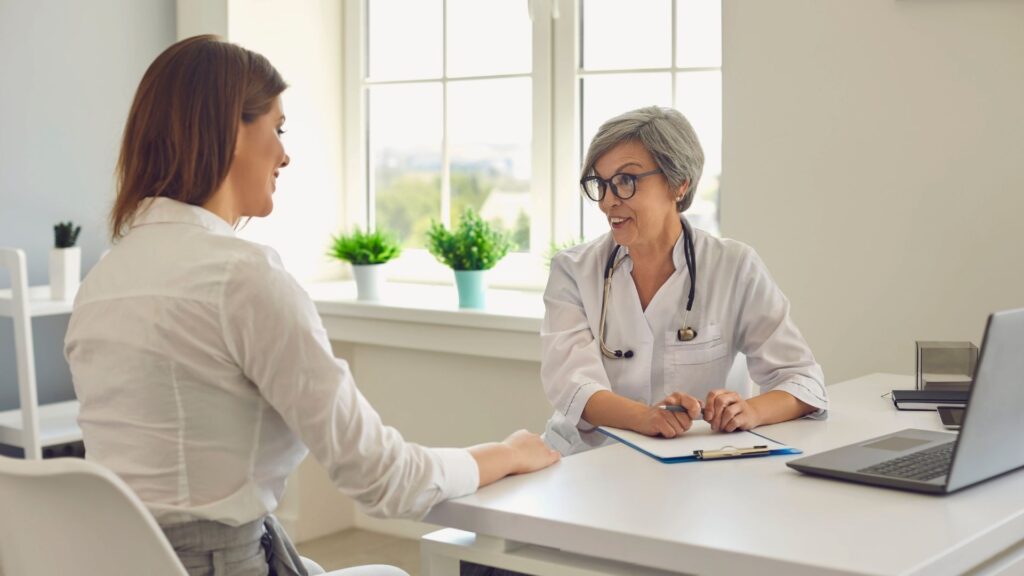 Doctor and patient talking about treatment progress in a drug and alcohol rehab setting.