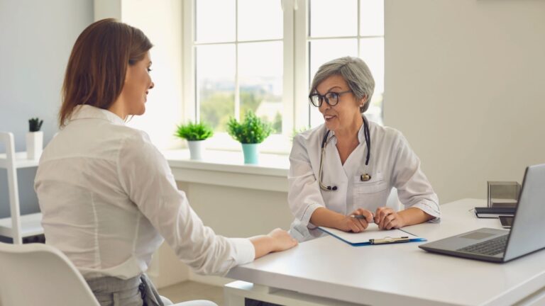 Doctor and patient talking about treatment progress in a drug and alcohol rehab setting.