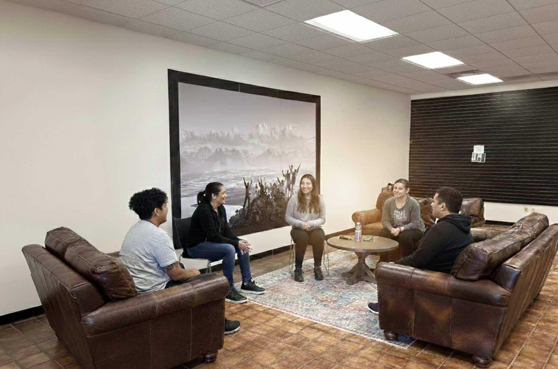 A diverse group of people participating in a supportive dual diagnosis treatment circle at Ridgeline Recovery.